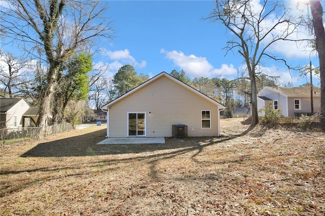 rear view of house featuring a yard and a patio