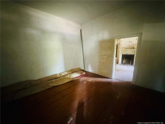 unfurnished room featuring a fireplace