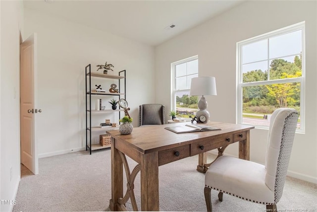 office featuring light carpet, visible vents, and baseboards