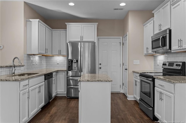 kitchen featuring white cabinets, appliances with stainless steel finishes, and sink