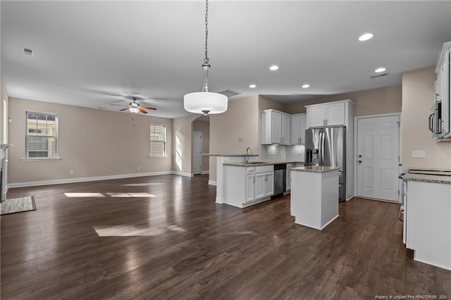 kitchen with appliances with stainless steel finishes, sink, dark hardwood / wood-style flooring, and white cabinetry