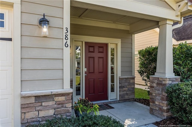 entrance to property featuring a porch