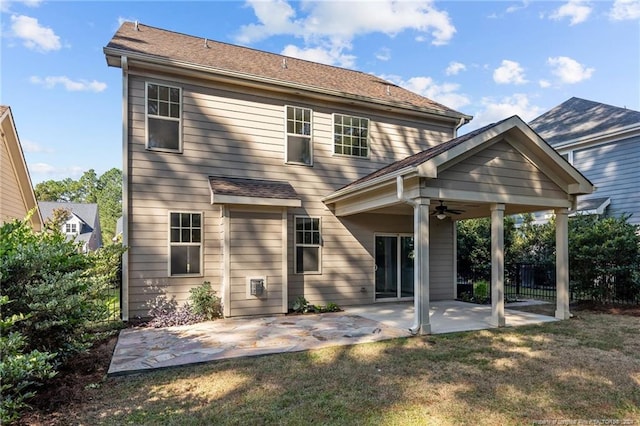 rear view of house featuring ceiling fan and a patio area