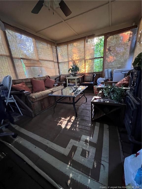 sunroom featuring ceiling fan