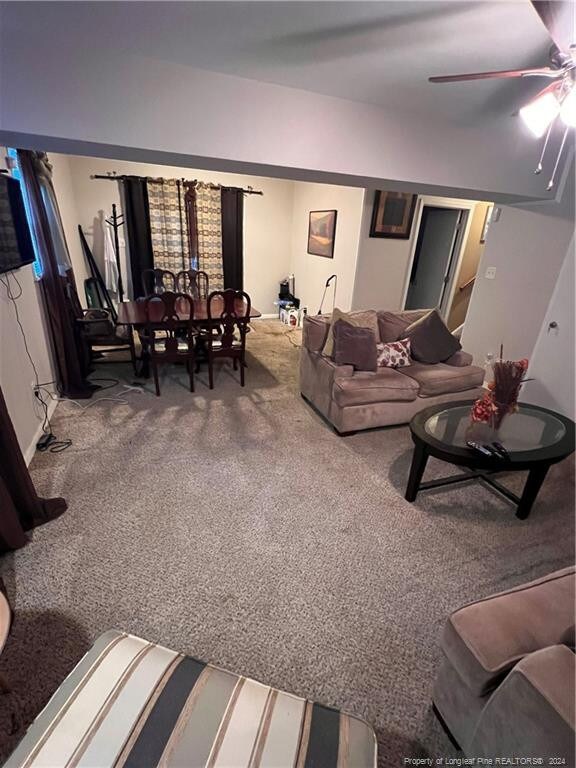 living room with carpet and ceiling fan