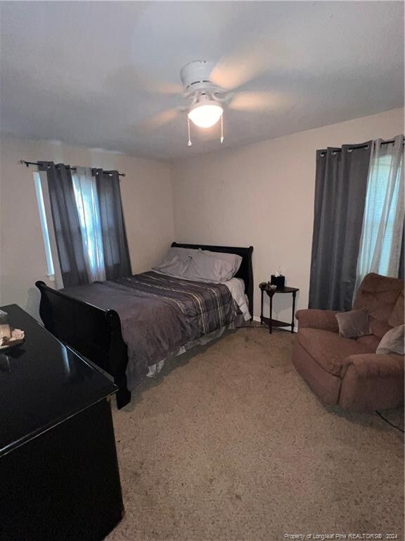 carpeted bedroom with ceiling fan