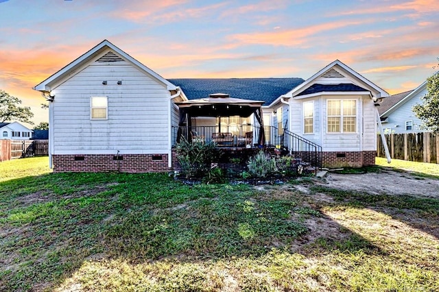 bungalow-style home with a lawn