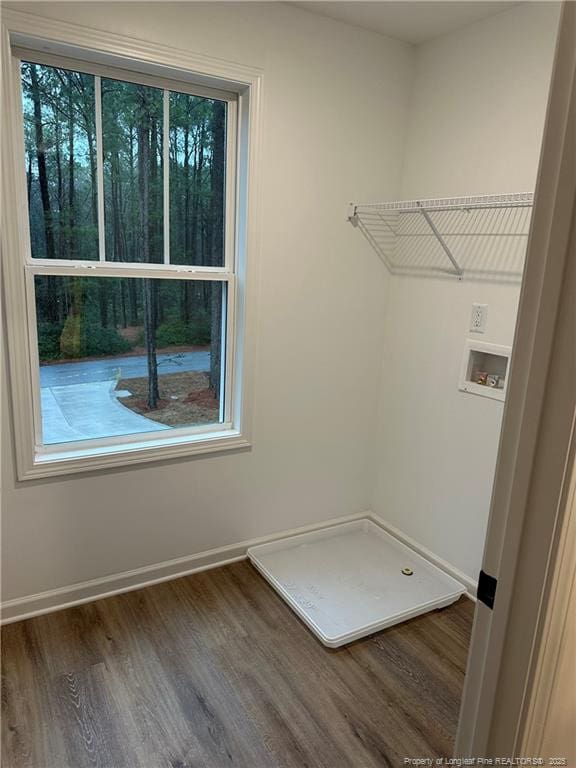 laundry room with dark hardwood / wood-style floors and washer hookup