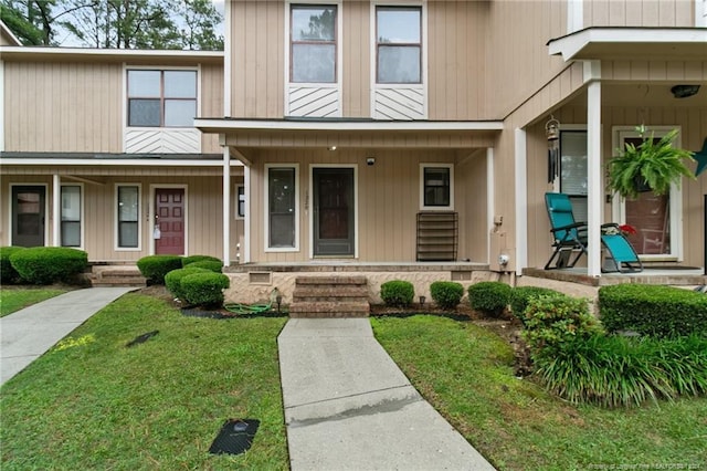 view of front of property with a front yard and a porch