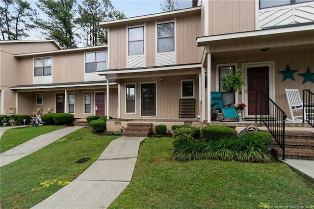 view of front facade with a front lawn and a porch