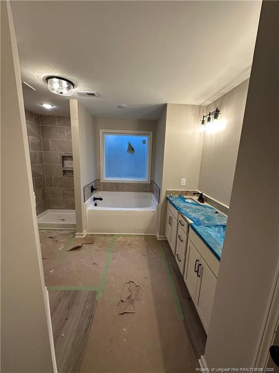 bathroom with vanity and a bathing tub