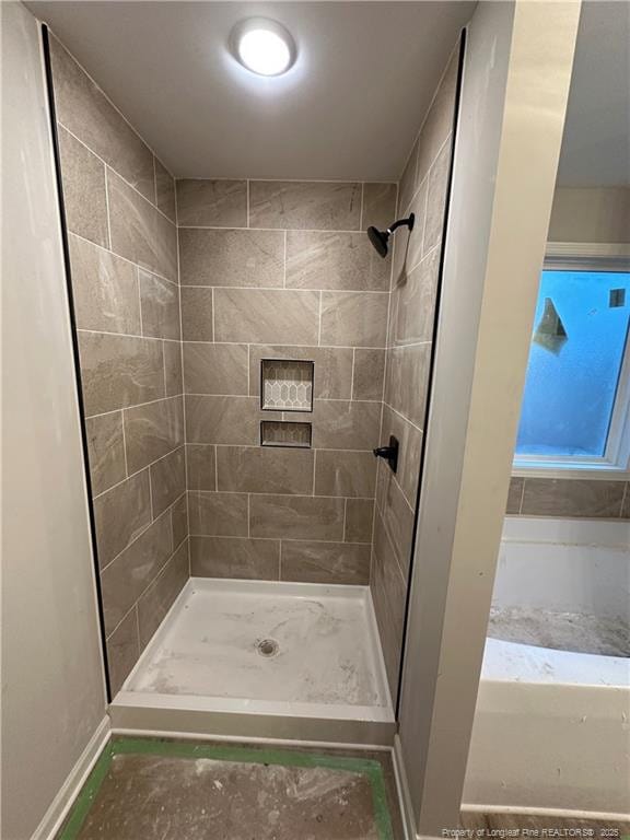 bathroom with a tile shower