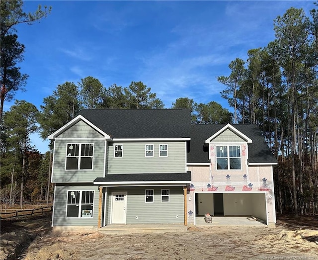 view of front of home with a garage and a patio area