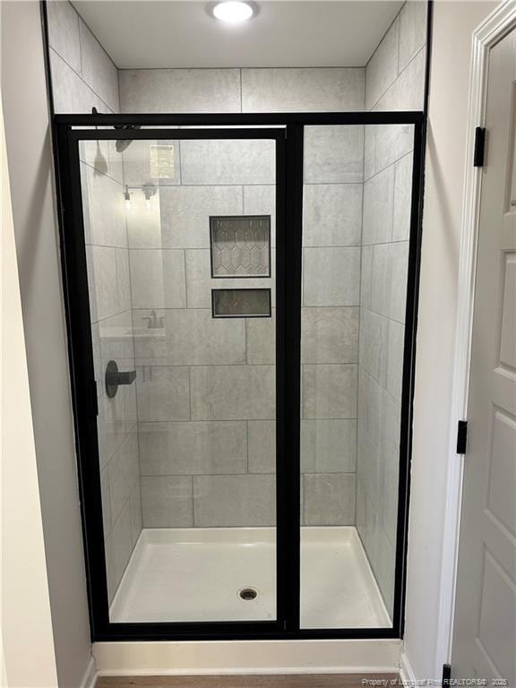 bathroom with a shower with shower door