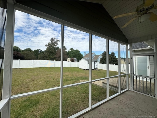 unfurnished sunroom featuring ceiling fan and vaulted ceiling