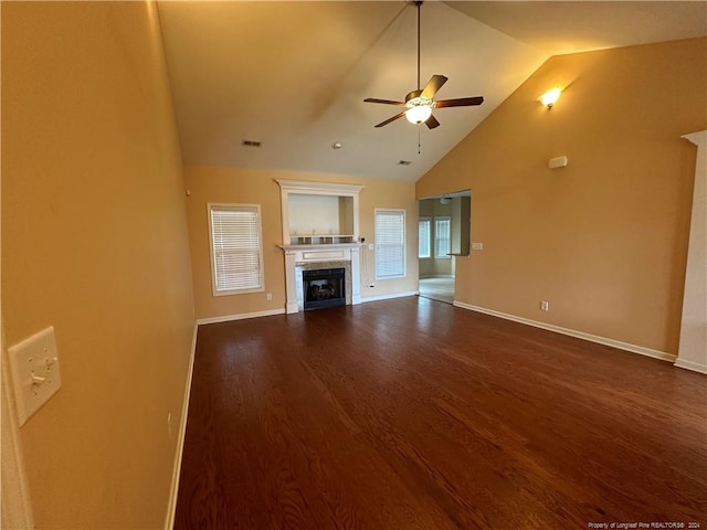 unfurnished living room featuring dark wood-type flooring, a fireplace, high vaulted ceiling, and ceiling fan