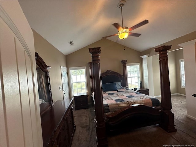 bedroom with lofted ceiling, decorative columns, dark colored carpet, and ceiling fan