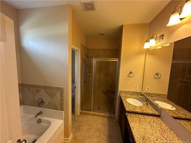 bathroom featuring vanity, independent shower and bath, and tile patterned flooring