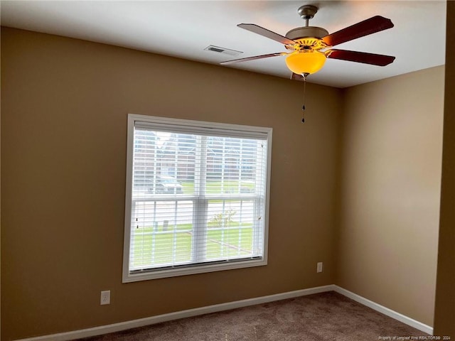 carpeted empty room featuring ceiling fan