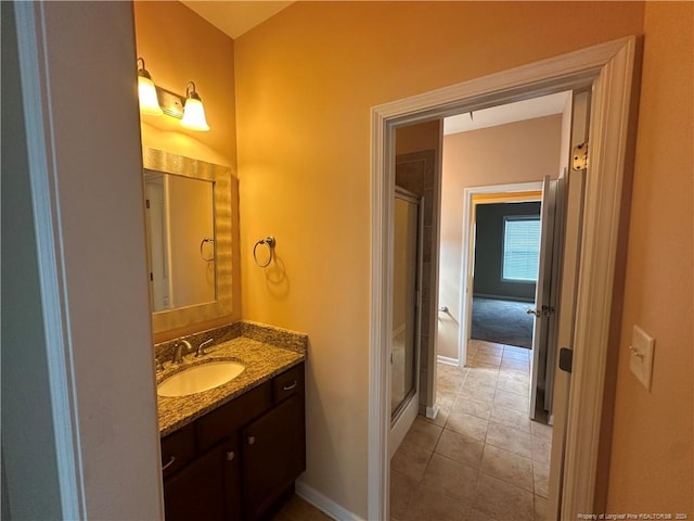 bathroom with vanity, tile patterned flooring, and an enclosed shower