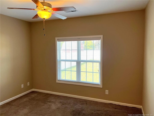 carpeted empty room featuring ceiling fan