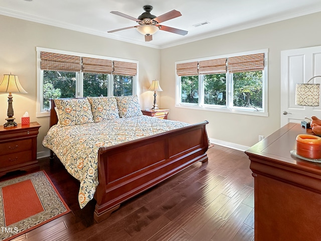 bedroom with dark hardwood / wood-style flooring, crown molding, and ceiling fan