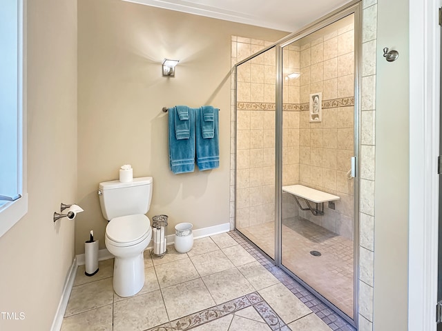 bathroom featuring toilet, an enclosed shower, and tile patterned flooring