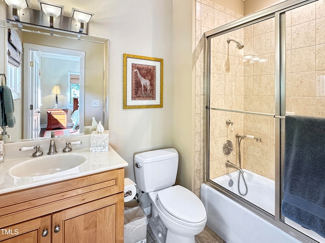 full bathroom with vanity, toilet, and combined bath / shower with glass door