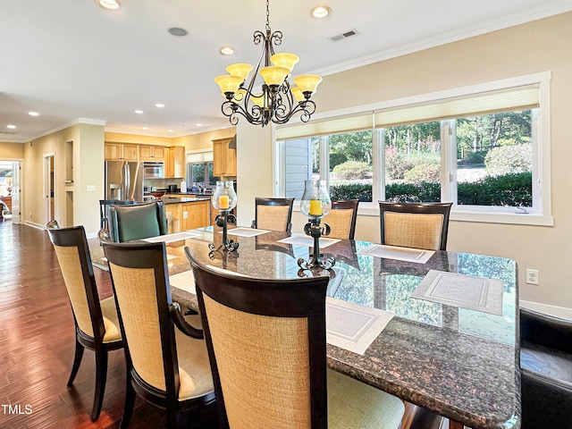 dining space with dark hardwood / wood-style flooring, ornamental molding, and plenty of natural light