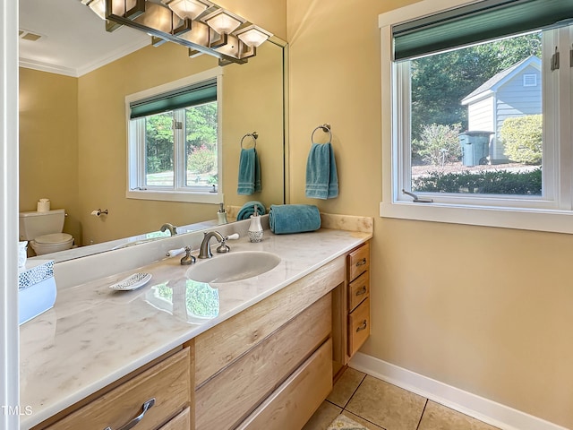 bathroom with vanity, crown molding, toilet, and tile patterned floors