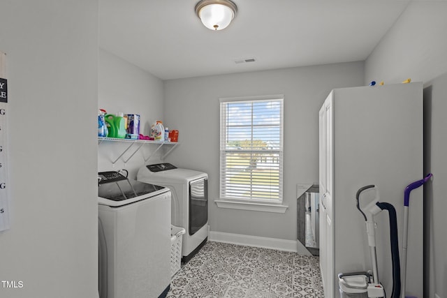 clothes washing area featuring separate washer and dryer