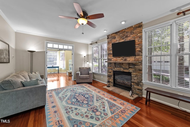 living room featuring ornamental molding, dark hardwood / wood-style flooring, and plenty of natural light