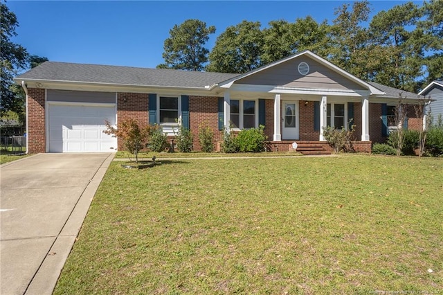 ranch-style home with covered porch, a front yard, and a garage