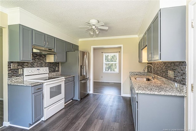 kitchen with stainless steel fridge, sink, dark hardwood / wood-style floors, electric stove, and light stone countertops