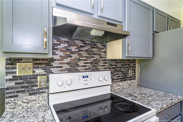 kitchen featuring tasteful backsplash, light stone countertops, and electric range