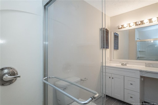 bathroom featuring walk in shower and vanity