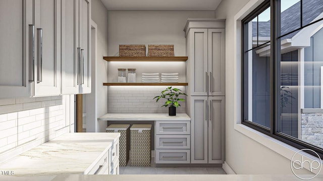 kitchen with gray cabinets and light tile patterned flooring