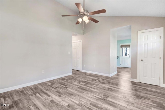 spare room with hardwood / wood-style flooring, ceiling fan, and lofted ceiling