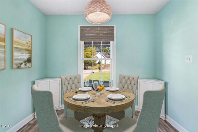 dining area featuring baseboards and wood finished floors