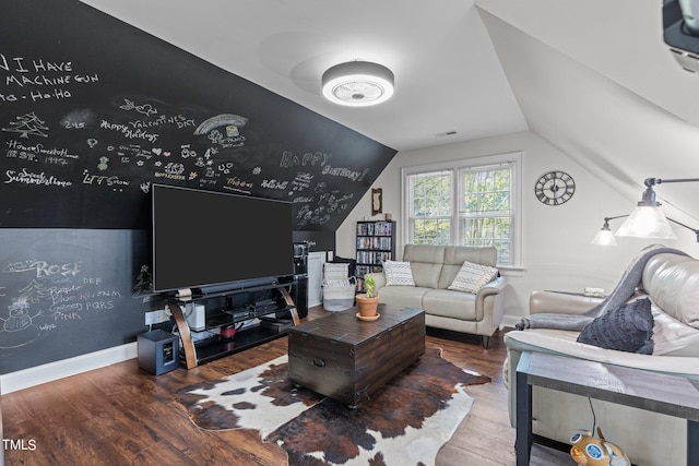 living room with hardwood / wood-style floors and vaulted ceiling