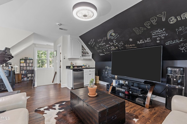 living room featuring lofted ceiling and dark hardwood / wood-style floors