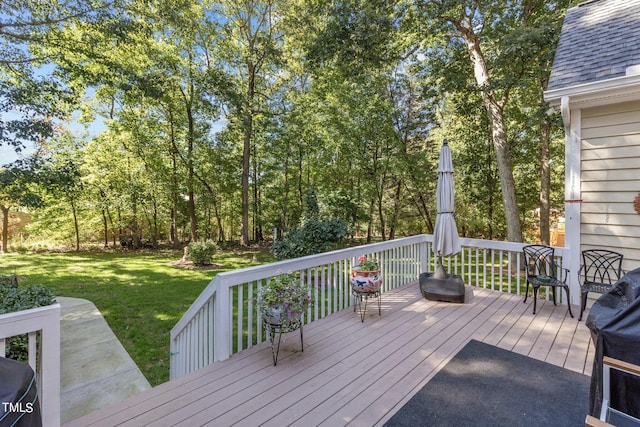 wooden deck with a lawn