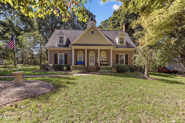 view of front facade featuring a front yard and covered porch