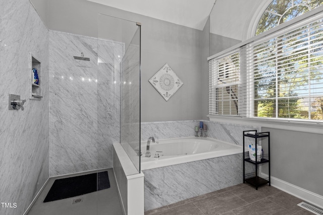 bathroom with tile patterned flooring, plenty of natural light, and plus walk in shower