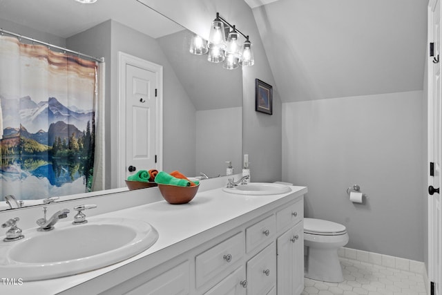 bathroom with lofted ceiling, tile patterned flooring, vanity, and toilet