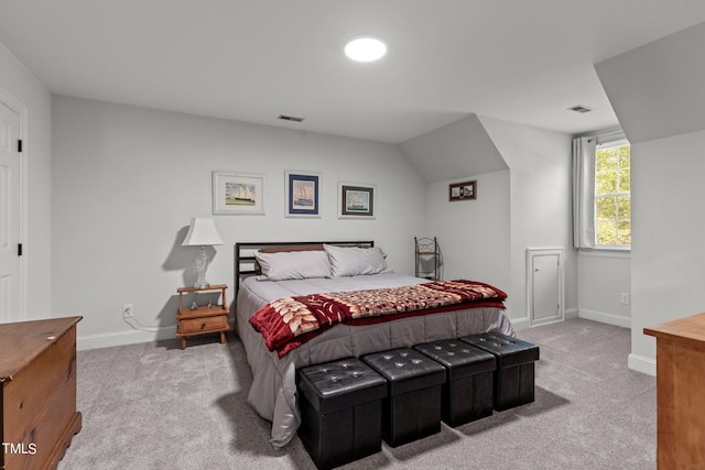 bedroom featuring lofted ceiling and carpet