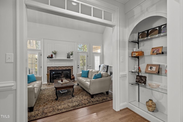 living room with a fireplace and light hardwood / wood-style flooring