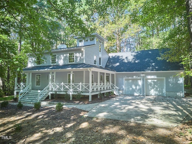 view of front facade with a garage and a porch