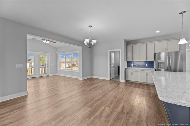 kitchen featuring white cabinetry, stainless steel fridge with ice dispenser, and hanging light fixtures