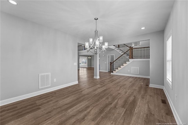 interior space featuring an inviting chandelier and dark hardwood / wood-style flooring